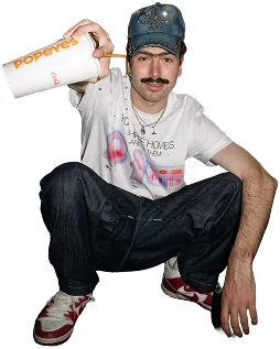 Community member crouching with a Popeyes cup