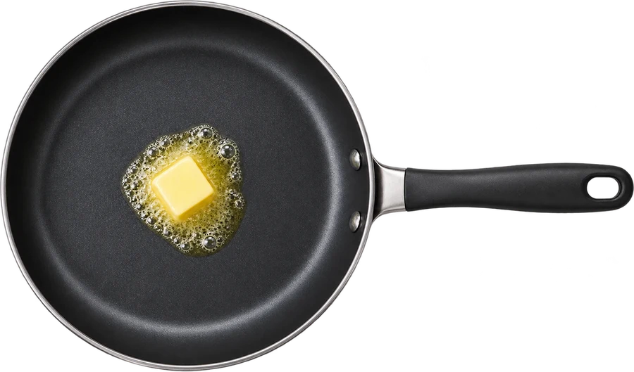 A frying pan with melting butter
